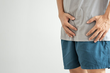 Man hold hand in front of private parts feeling discomfort from disease and inflammation. Venereal,...