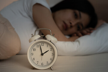 asian woman in bed late trying to sleep suffering insomnia, sleepless or scared in a nightmare,...