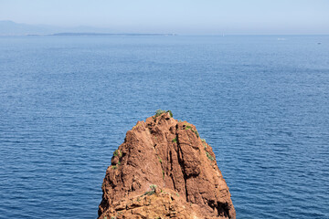 Steep coast on the Cote d'Azur, French Riviera, overlooking the open Mediterranean Sea with ships