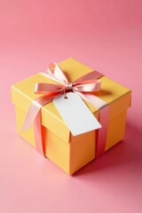 Obraz premium Elegant gift box, satin ribbon, blank tag Yellow pink background , pastel, packaging design