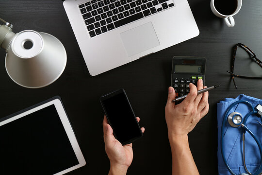 Medical Professional Office Desk with Calculator, Laptop, and Stethoscope