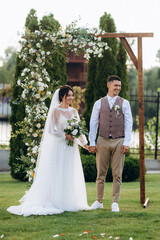 wedding ceremony of a young couple in love on a green meadow