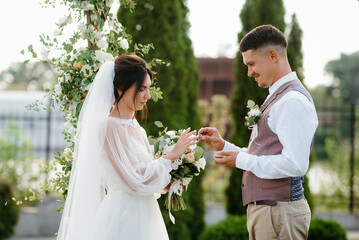wedding ceremony of a young couple in love on a green meadow