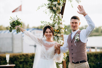 wedding ceremony of a young couple in love on a green meadow