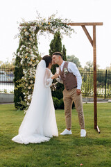 wedding ceremony of a young couple in love on a green meadow
