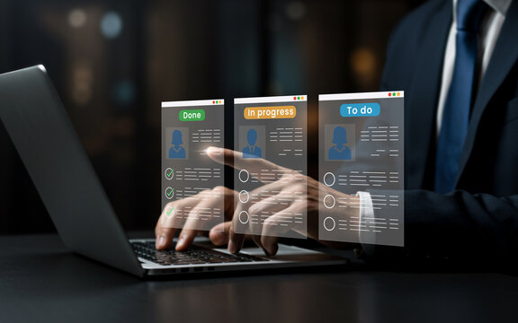 Businessman using laptop to manage tasks on a digital interface