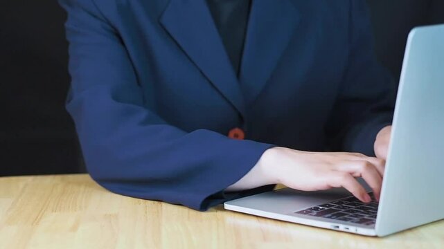 businesswoman working on a computer keyboard with AI elements, representing the integration of artificial intelligence in daily work, digital transformation, and modern business strategies.