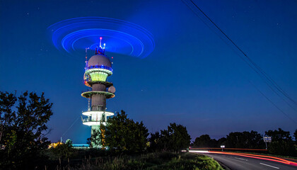 Tracking Radar Tower with Pulsing Blue Glow and Rotating Beam Trail in Dark Background