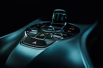 Close-up view of an electric vehicle's center console, showcasing the control panel, which...