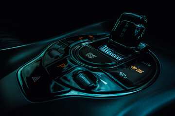 Close-up view of an electric vehicle's center console, showcasing the control panel, which...