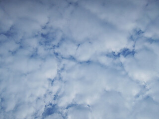 Bright Blue Sky Covered with Fluffy White Clouds on a Clear Day