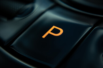 Close-up view of an electric vehicle's center console, showcasing the control panel, which...