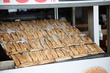 Rows of grilled fish fillets for balik sandwitches a street food in Istanbul, Turkey