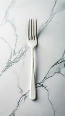 A single white handled fork rests on a white marble surface with prominent grey veining