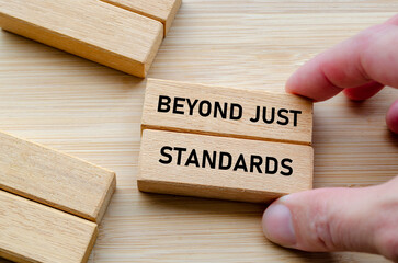 Beyond just standards text on wooden blocks in hand highlights action and truth beyond mere statements