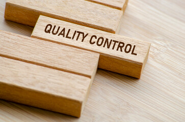 Quality Control text on wooden blocks. Business and Quality control concept