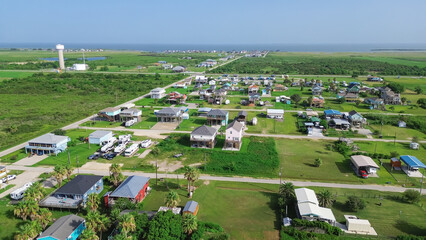 Bolivar Peninsula Water Tower along Texas State Highway 87 and community of colorful raised beach...