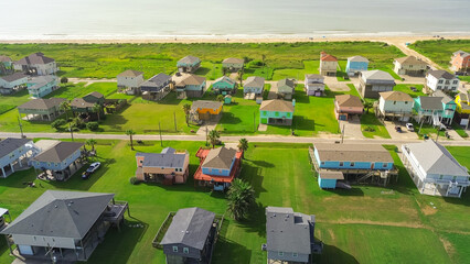 Elevated colorful beach house in oceanside neighborhood with road access to sandy shoreline. Ideal...