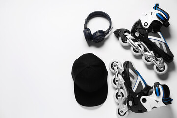 Flat lay composition with roller skates on white background. Space for text