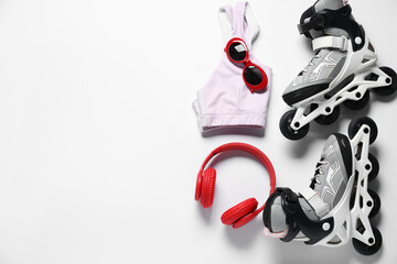 Flat lay composition with roller skates on white background. Space for text