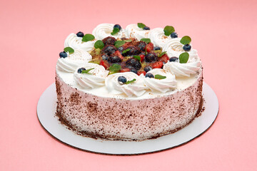 Delicious berry-topped cream cake on pink background for special occasions and celebrations