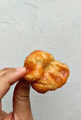 Hand Holding Delicious Indonesian Cakwe Snack