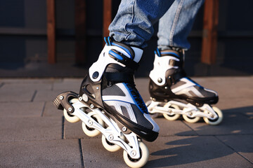 Man roller skating on city street, closeup