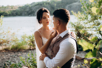 bride blonde girl and groom near the river