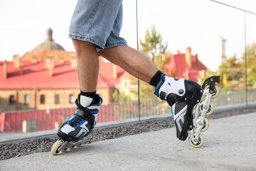 Man roller skating on city street, closeup
