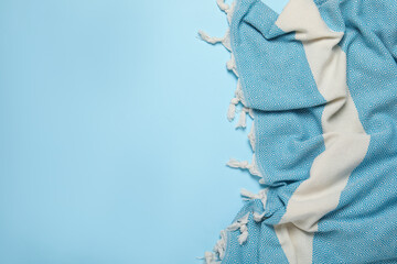 Striped beach towel on light blue background, top view. Space for text