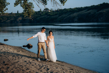 bride girl and groom near the river