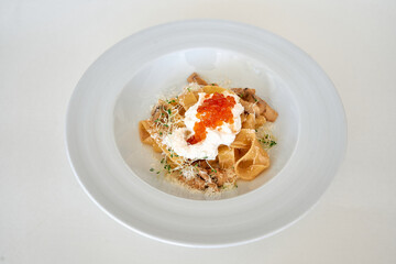 Gourmet pappardelle with creamy oyster mushrooms, caviar, and fresh sprouts garnish