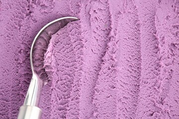 Tasty blueberry sorbet and metal spoon, top view. Space for text