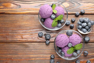 Tasty sorbet with blueberries and mint served on wooden table, flat lay. Space for text