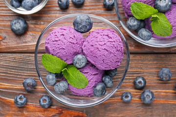 Tasty sorbet with blueberries and mint served on wooden table, flat lay