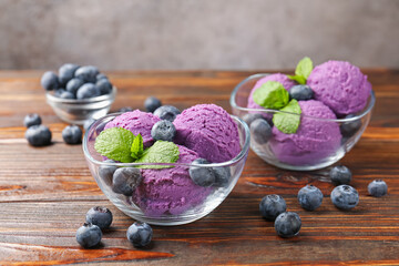 Tasty sorbet with blueberries and mint served on wooden table, closeup