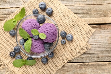 Tasty sorbet with blueberries and mint served on wooden table, flat lay. Space for text