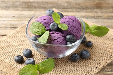 Tasty sorbet with blueberries and mint served on wooden table, closeup