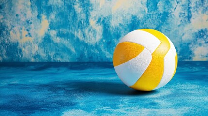 Yellow and white volleyball on blue background.