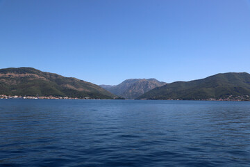 View of the mountain range and coastal towns from the water. Sea. Montenegro