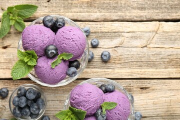 Tasty sorbet with blueberries and mint in dessert bowls on wooden table, flat lay. Space for text