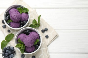 Tasty sorbet with blueberries and mint in bowls on white wooden table, top view. Space for text