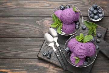 Tasty sorbet with blueberries and mint in dessert bowls on wooden table, flat lay. Space for text