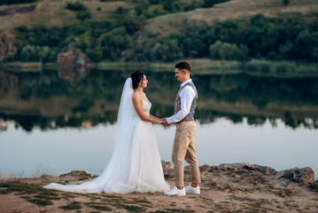 bride girl and groom near the river