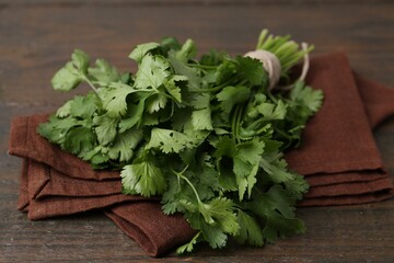 Fresh aromatic cilantro on wooden table, closeup
