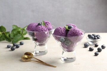 Tasty sorbet with blueberries and mint on light grey table