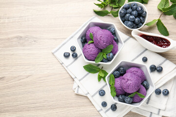 Tasty sorbet with blueberries, mint and jam on wooden table, flat lay. Space for text
