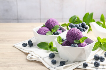 Tasty sorbet with blueberries and mint on wooden table, closeup. Space for text