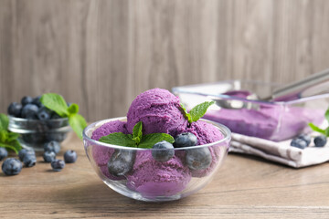 Tasty sorbet with blueberries and mint on wooden table, closeup