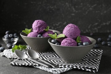 Tasty sorbet with blueberries and mint on black table, closeup